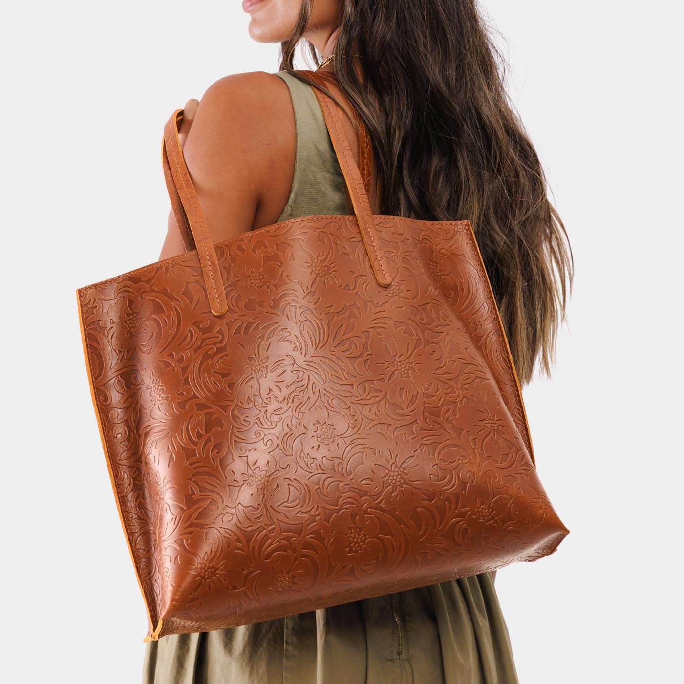 Meadow*Large | Model holding leather tote bag with interior snap key loop
