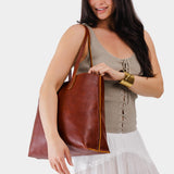 Nutmeg Large | Model holding leather tote bag with interior snap key loop