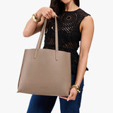 Stone Large | Model holding leather tote bag with matching leather handles