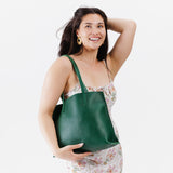 Bacalar Medium | Model holding leather tote bag with interior snap key loop