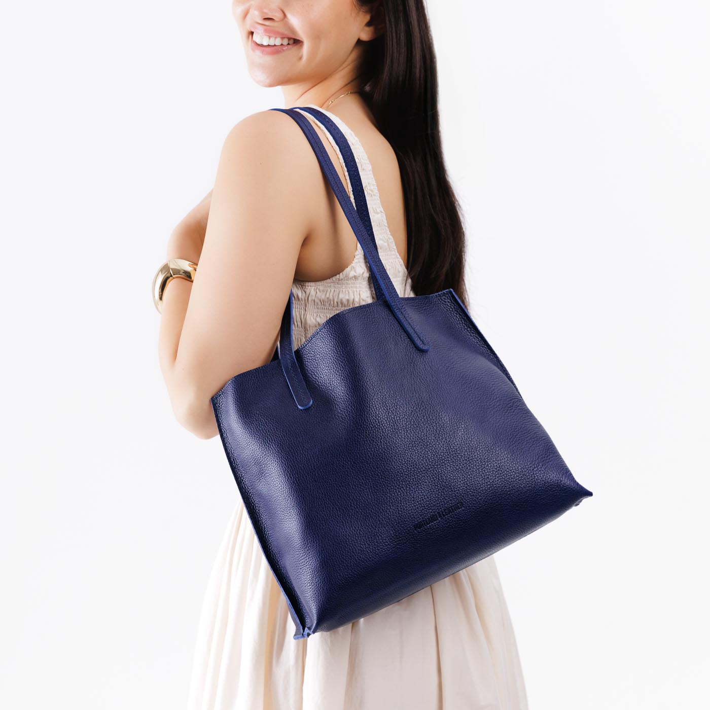 Cobalt*Medium | Model holding leather tote bag with interior snap key loop
