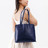 Cobalt Medium | Model holding leather tote bag with interior snap key loop
