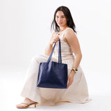 All Variants | Model holding a Medium Cobalt August Tote