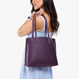 Empire Medium | Model holding leather tote bag with matching leather handles