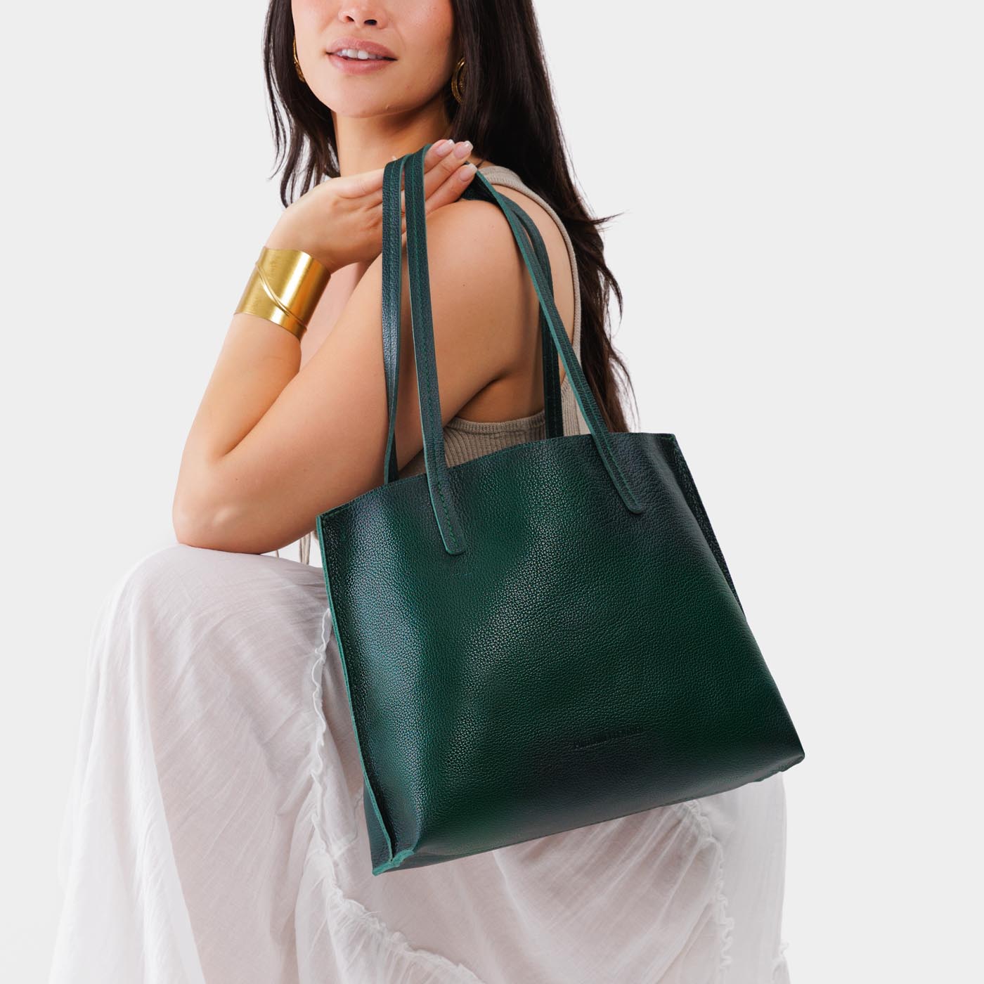 Forest Green*Medium | Model holding leather tote bag with interior snap key loop