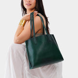 Forest Green Medium | Model holding leather tote bag with interior snap key loop