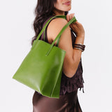 Green Apple Medium | Model holding leather tote bag with interior snap key loop