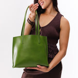 Green Apple Medium | Model holding leather tote bag with interior snap key loop