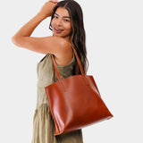 Madrone Medium | Model holding leather tote bag with interior snap key loop