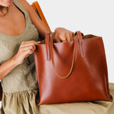 Madrone Medium | Model holding leather tote bag with interior snap key loop