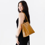 Mango Medium | Model holding leather tote bag with interior snap key loop