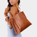 Meadow Medium | Model holding leather tote bag with interior snap key loop