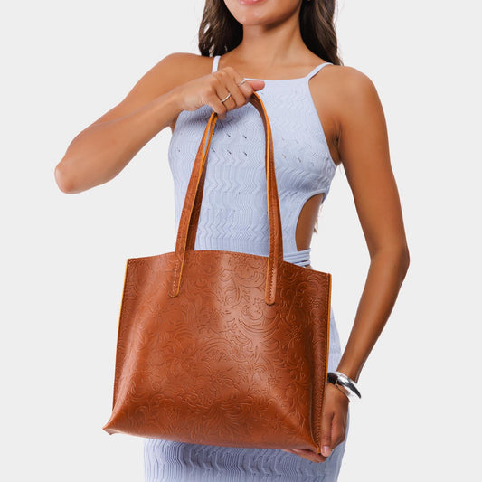 Meadow*Medium | Model holding leather tote bag with interior snap key loop