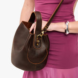 Coldbrew Large | Model holding symmetrical bucket bag with handle, latch closure, and removable crossbody strap