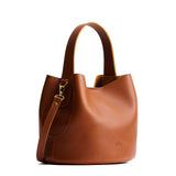 Honey Small | Symmetrical bucket bag with handle, latch closure, and removable crossbody strap