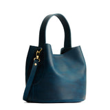 Westward Blue Small | Symmetrical bucket bag with handle, latch closure, and removable crossbody strap