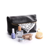 Pebbled--black | Closed folded zipper pouch with items