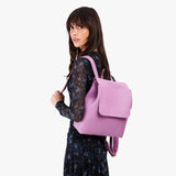 Calla Lily | Model wearing a leather backpack on a white background