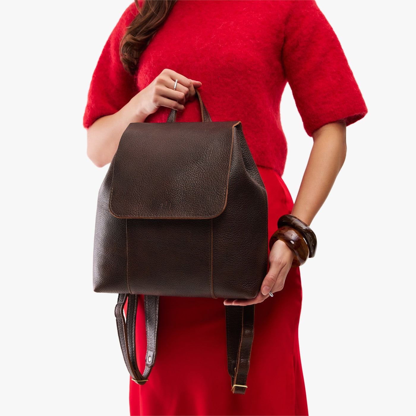 Coldbrew | Model wearing a leather backpack on a white background