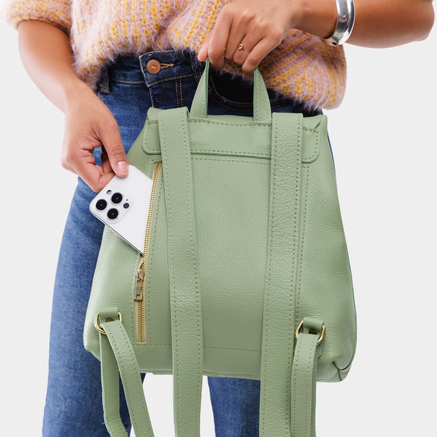 Pistachio | Model wearing a leather backpack on a white background