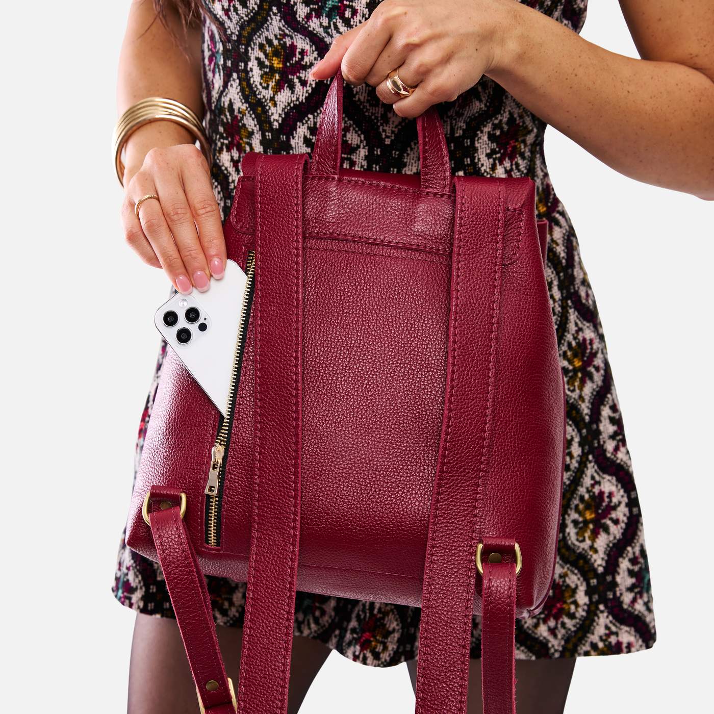 Rhubarb | Model wearing a leather backpack on a white background