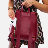 Rhubarb | Model wearing a leather backpack on a white background