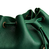 Bacalar | Close-up of leather drawstring backpack with grommets.