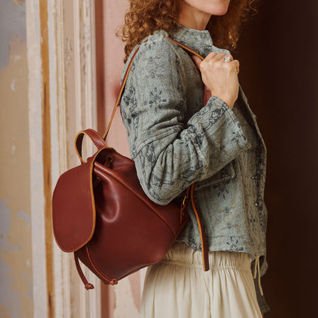 Nutmeg | Drawstring bucket backpack with snap closure under flap