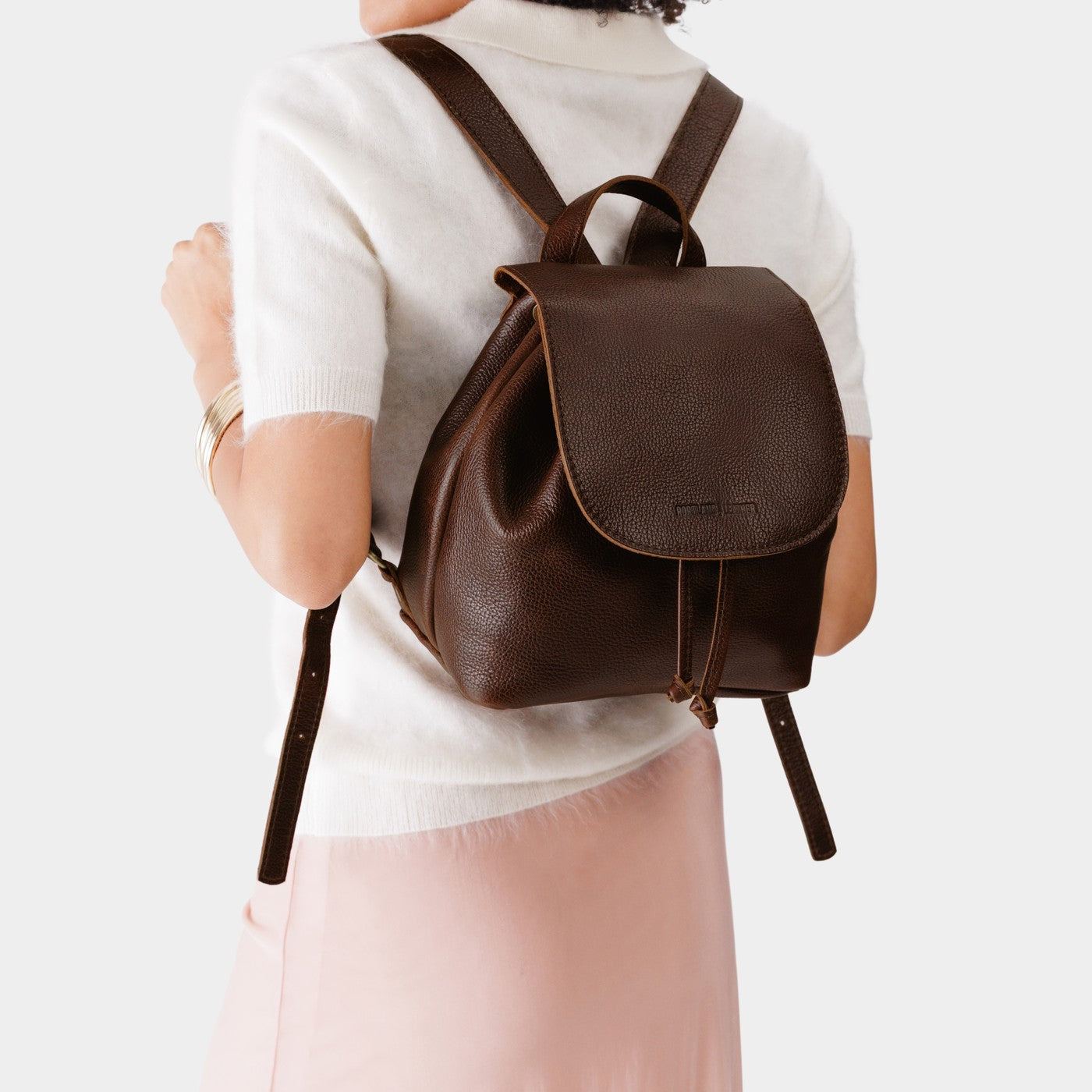 Coldbrew | Pebbled leather drawstring backpack being worn by a person.