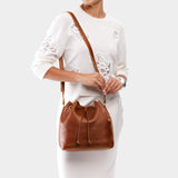 Nutmeg Large | Model wearing slouchy crossbody bag with drawstring closure