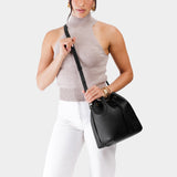 Pebbled--black Large | Model holding slouchy crossbody bag with drawstring closure