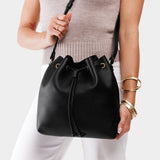 Pebbled--black Large | Model holding slouchy crossbody bag with drawstring closure