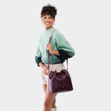 Plum Large | Model wearing slouchy crossbody bag with drawstring closure