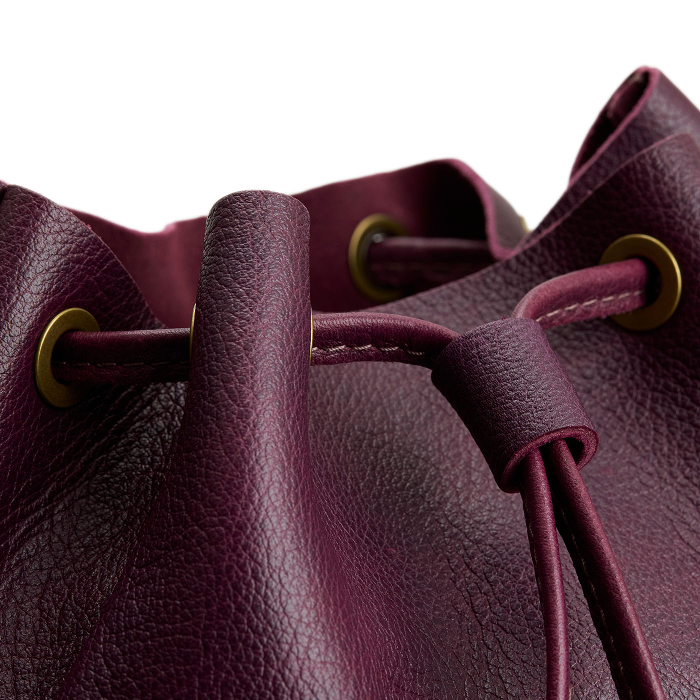 Plum | Close-up of slouchy crossbody bag with leather drawstring closure