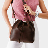 Coldbrew Large | Model holding slouchy crossbody bag with drawstring closure