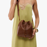 Asheville Small | Model wearing slouchy crossbody bag with drawstring closure