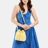 Butter Bliss Small | Model wearing slouchy crossbody bag with drawstring closure