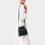 Boreal Small | Model wearing slouchy crossbody bag with drawstring closure