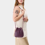 Plum Small | Model wearing slouchy crossbody bag with drawstring closure