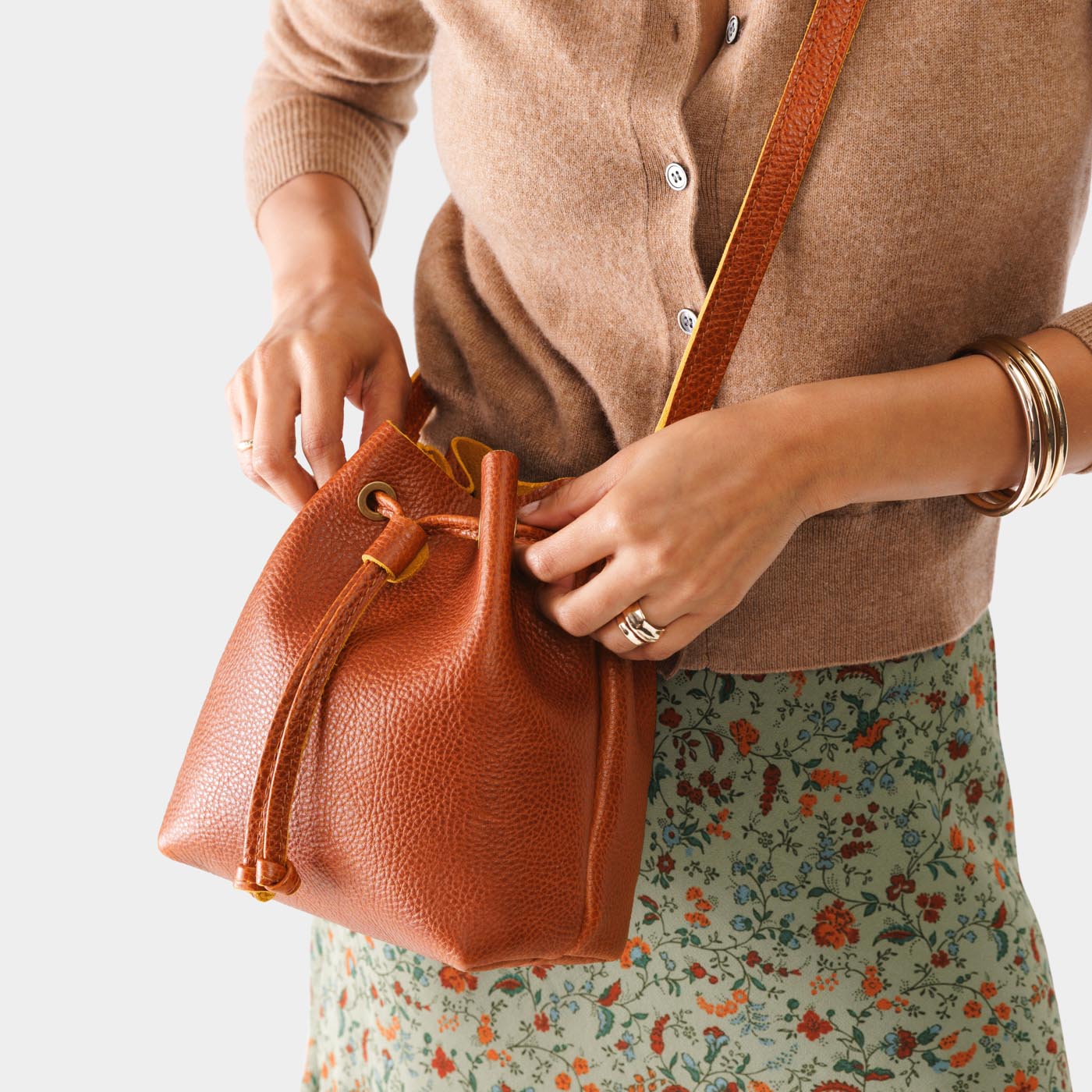 Sienna*Small | Model holding slouchy crossbody bag with drawstring closure