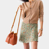 Sienna Small | Model holding slouchy crossbody bag with drawstring closure