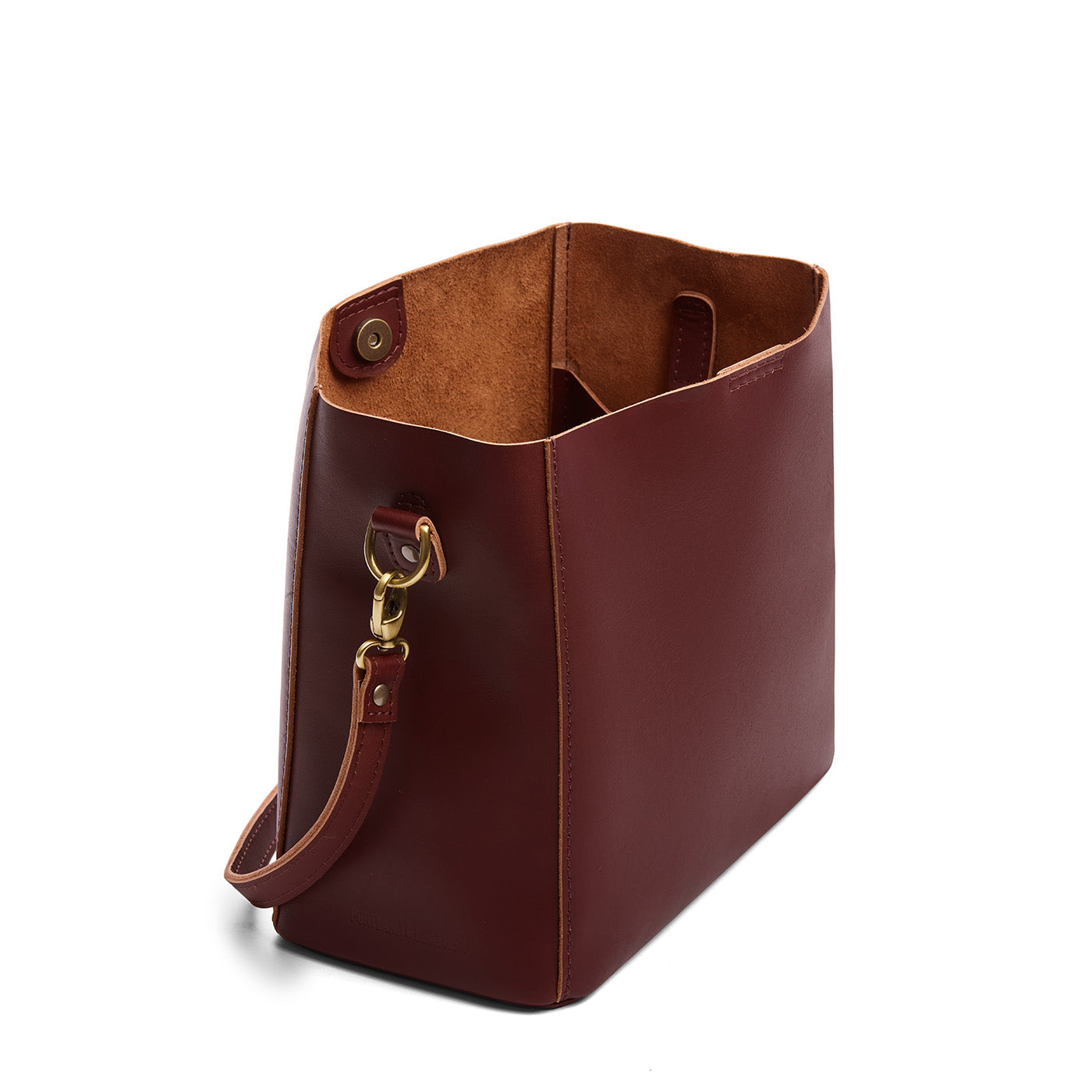 Cognac | Symmetrical bucket bag with latch closure and removable crossbody strap