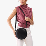 Dahlia Large | Model wearing circle shaped crossbody bag with top zipper
