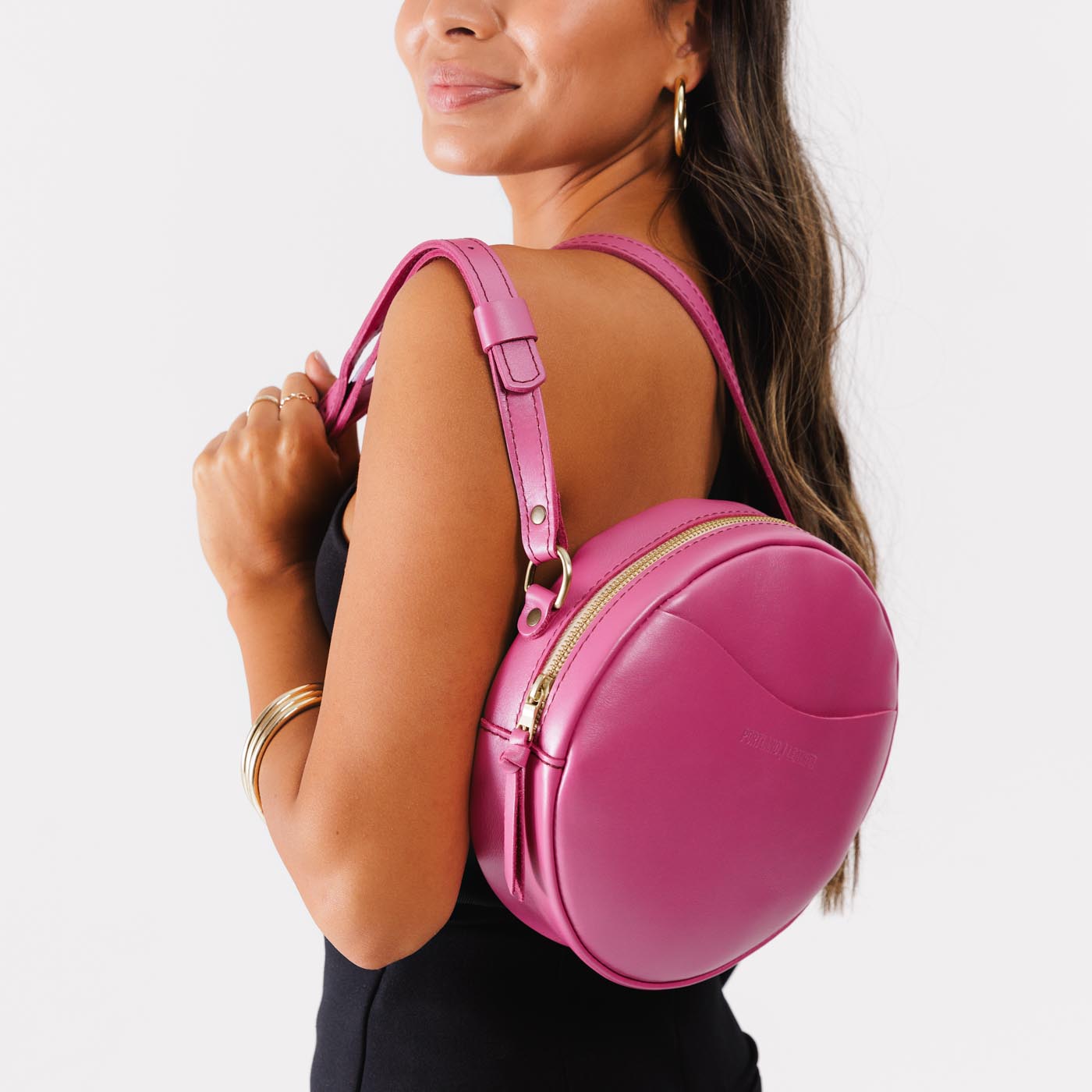 Lip Gloss*Large | Model holding circle shaped crossbody bag with top zipper