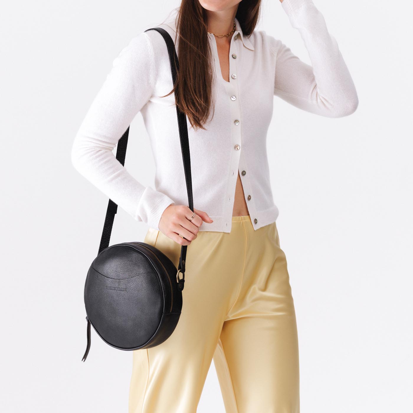 Circle shaped crossbody bag with top zipper