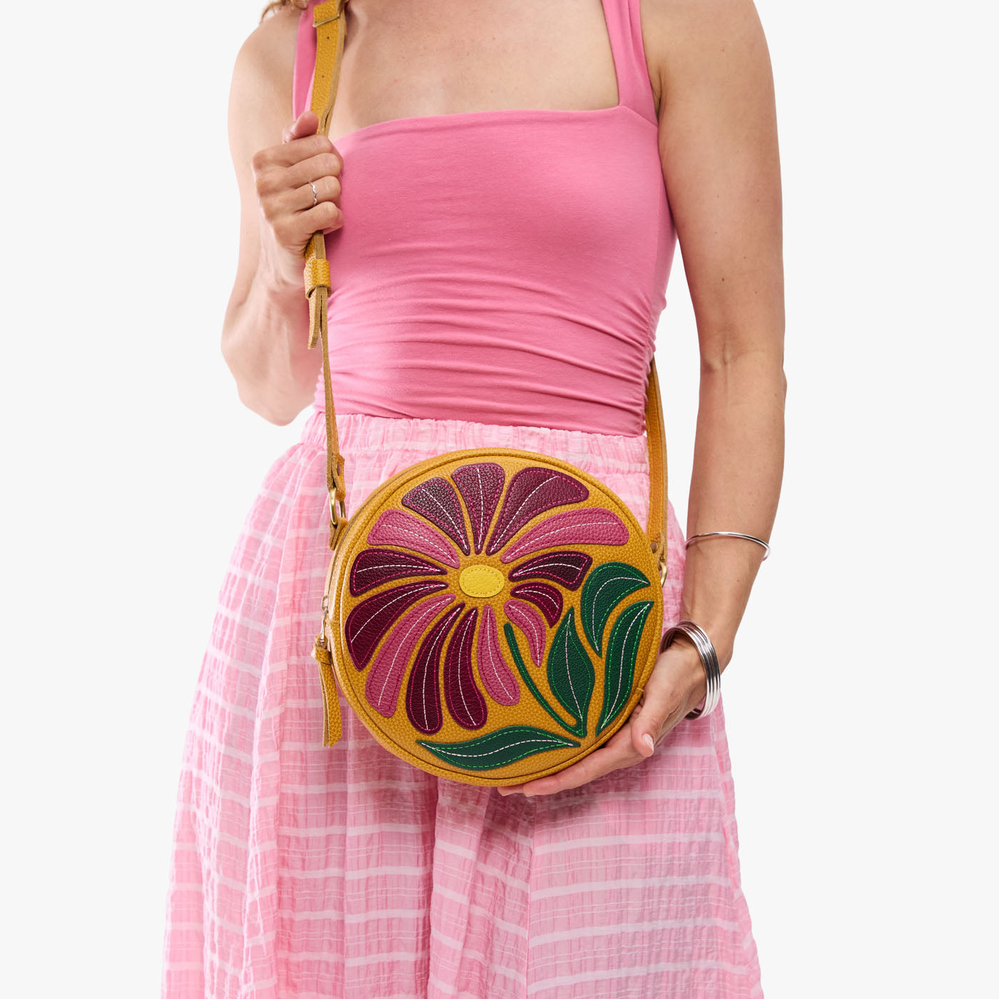 Wildflower Sunshine*Large | Model holding circle shaped crossbody bag with top zipper