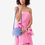 Aster Small | Model wearing circle shaped crossbody bag with top zipper