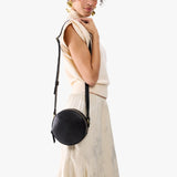 Dahlia Small | Model wearing circle shaped crossbody bag with top zipper