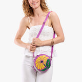 Wildflower Cattleya Small | Model wearing circle shaped crossbody bag with top zipper