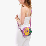 Wildflower Cattleya Small | Model wearing circle shaped crossbody bag with top zipper